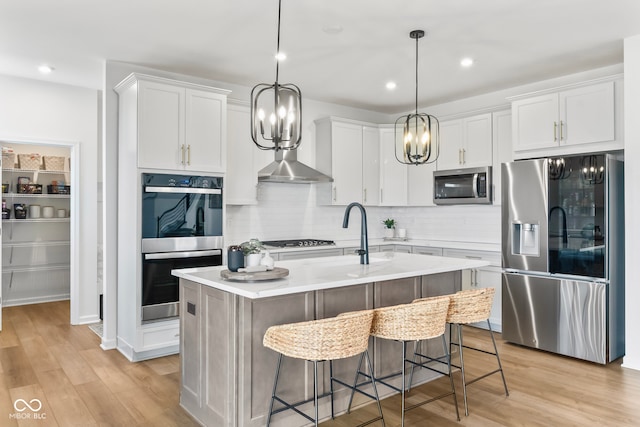 13644 Haven Cove Ln, Fishers, IN 46055 - kitchen with appliances with stainless steel finishes, light countertops, light wood-type flooring, tasteful backsplash, and recessed lighting