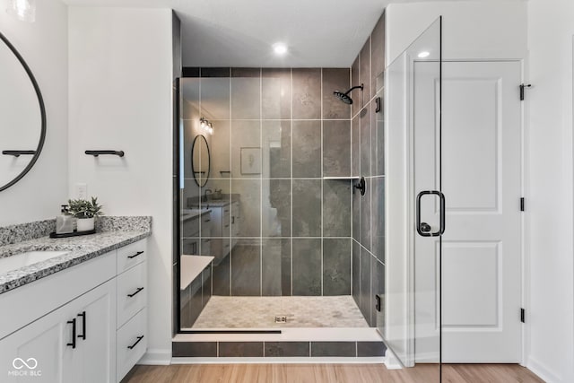 13644 Haven Cove Ln, Fishers, IN 46055 - full bathroom featuring vanity, a stall shower, wood finished floors, and recessed lighting