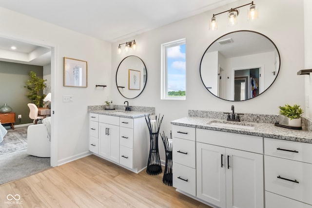 13644 Haven Cove Ln, Fishers, IN 46055 - bathroom featuring wood finished floors, two vanities, and ensuite bathroom
