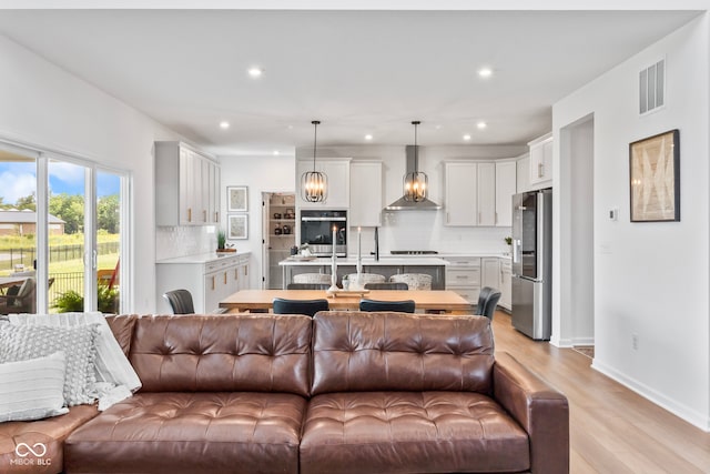 13644 Haven Cove Ln, Fishers, IN 46055 - living room with recessed lighting, light wood-style floors, and a chandelier
