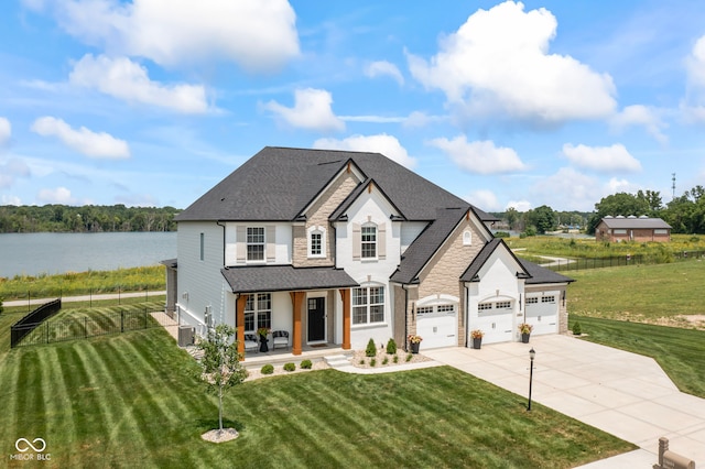 13644 Haven Cove Ln, Fishers, IN 46055 - french country style house with covered porch, driveway, a garage, a shingled roof, and stone siding