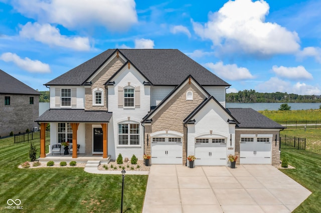 13644 Haven Cove Ln, Fishers, IN 46055 - french country inspired facade featuring a porch, a garage, driveway, stone siding, and a shingled roof