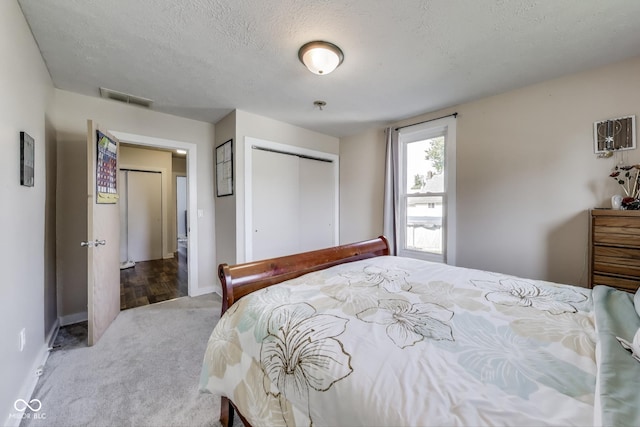 307 E Walnut St, Lebanon, IN 46052 - bedroom with carpet floors, a closet, and a textured ceiling