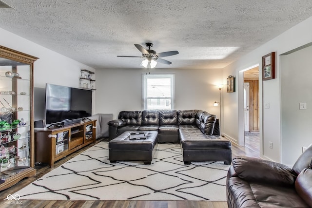 307 E Walnut St, Lebanon, IN 46052 - living room with wood finished floors, a ceiling fan, and a textured ceiling