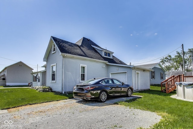 307 E Walnut St, Lebanon, IN 46052 - view of property exterior featuring a garage, a yard, and asphalt driveway