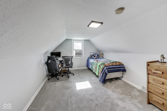 307 E Walnut St, Lebanon, IN 46052 - carpeted bedroom featuring a textured ceiling, lofted ceiling, and a desk