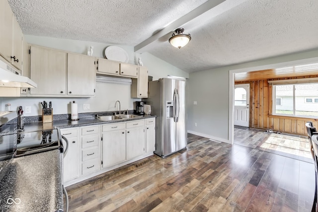 307 E Walnut St, Lebanon, IN 46052 - kitchen featuring appliances with stainless steel finishes, wood finished floors, a textured ceiling, under cabinet range hood, and dark countertops