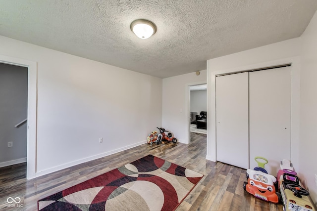 307 E Walnut St, Lebanon, IN 46052 - bedroom with wood finished floors, a closet, and a textured ceiling