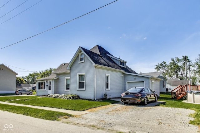 307 E Walnut St, Lebanon, IN 46052 - view of front of house featuring a front yard, a garage, and roof with shingles