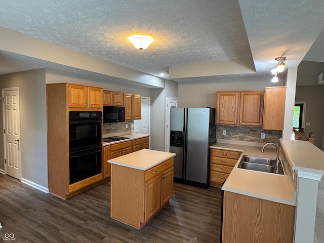 14520 Brackney Ln, Carmel, IN 46032 - kitchen featuring black appliances, a textured ceiling, dark wood-style floors, light countertops, and a peninsula