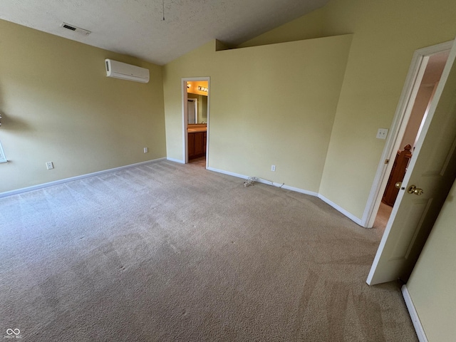 14520 Brackney Ln, Carmel, IN 46032 - empty room with a wall mounted AC, lofted ceiling, light colored carpet, and a textured ceiling