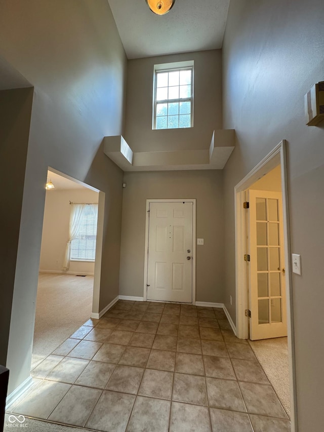 14520 Brackney Ln, Carmel, IN 46032 - foyer entrance featuring a high ceiling, light tile patterned floors, and light colored carpet
