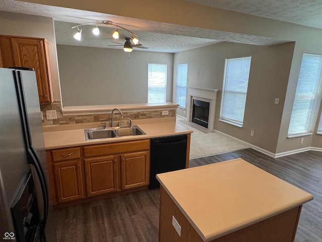 14520 Brackney Ln, Carmel, IN 46032 - kitchen with freestanding refrigerator, dishwasher, open floor plan, brown cabinets, and dark wood-type flooring