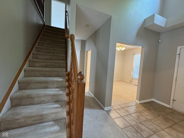 14520 Brackney Ln, Carmel, IN 46032 - stairway featuring carpet flooring, a chandelier, and tile patterned floors