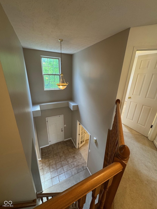 14520 Brackney Ln, Carmel, IN 46032 - entryway featuring a textured ceiling and carpet flooring