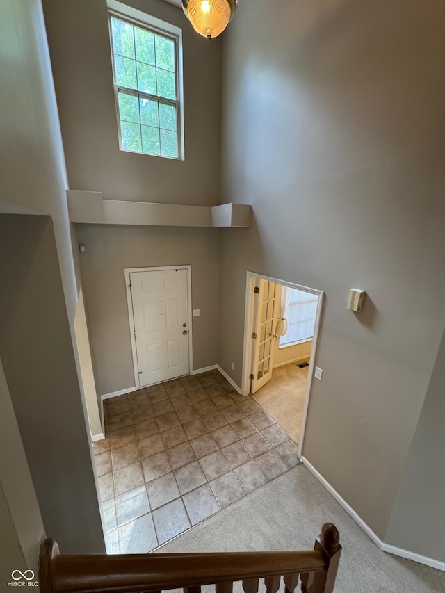 14520 Brackney Ln, Carmel, IN 46032 - carpeted entrance foyer featuring a towering ceiling and tile patterned floors