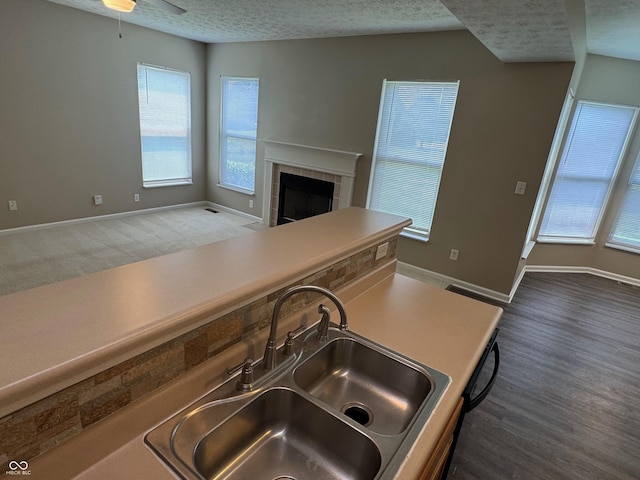 14520 Brackney Ln, Carmel, IN 46032 - kitchen with a textured ceiling, a tile fireplace, open floor plan, wood finished floors, and ceiling fan