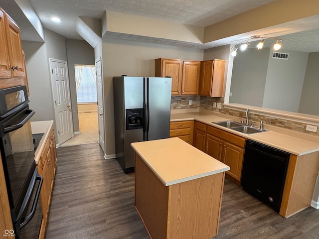 14520 Brackney Ln, Carmel, IN 46032 - kitchen with black appliances, tasteful backsplash, a textured ceiling, dark wood-type flooring, and light countertops