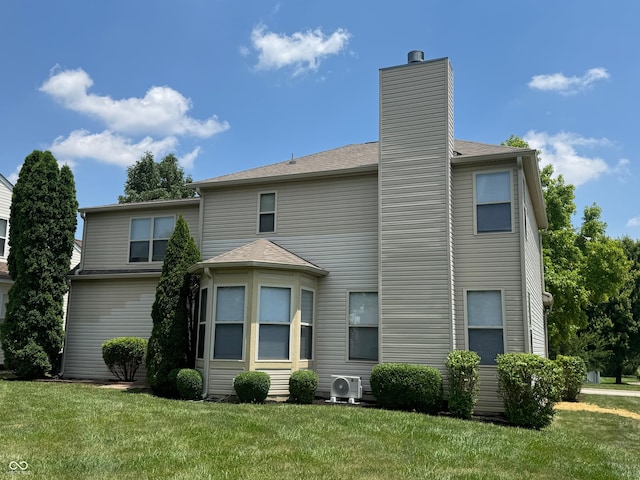 14520 Brackney Ln, Carmel, IN 46032 - rear view of property featuring a chimney and a yard