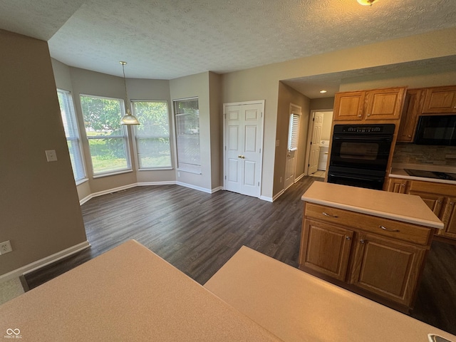 14520 Brackney Ln, Carmel, IN 46032 - kitchen with black appliances, dark wood-type flooring, light countertops, brown cabinetry, and a textured ceiling