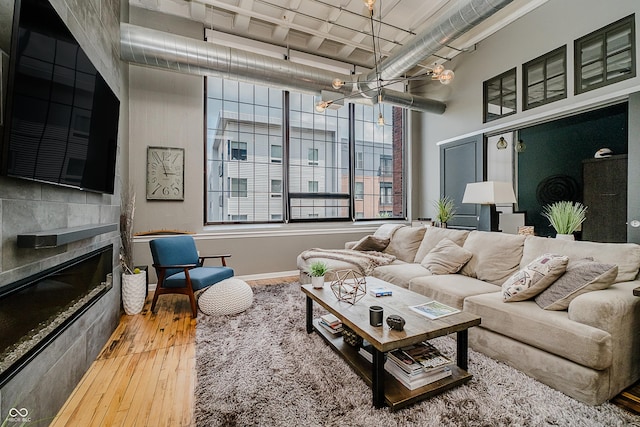 624 E Walnut St Unit 26, Indianapolis, IN 46204 - living room with a chandelier, hardwood / wood-style flooring, and a glass covered fireplace
