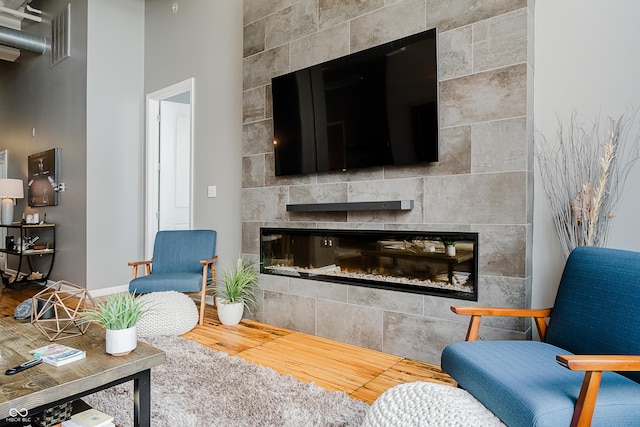 624 E Walnut St Unit 26, Indianapolis, IN 46204 - living room with a tile fireplace and wood finished floors