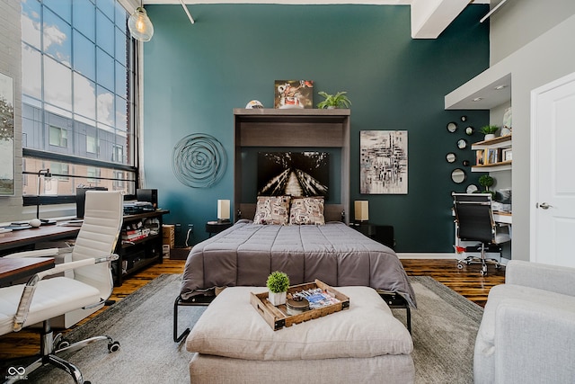 624 E Walnut St Unit 26, Indianapolis, IN 46204 - bedroom with wood finished floors, a towering ceiling, and a desk
