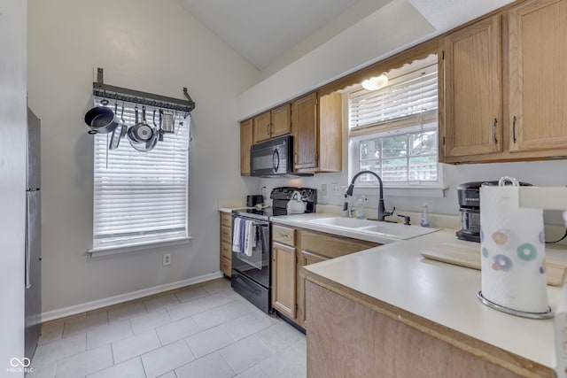 9676 Spruce Ln, Fishers, IN 46038 - kitchen with black appliances, light countertops, vaulted ceiling, and light tile patterned floors