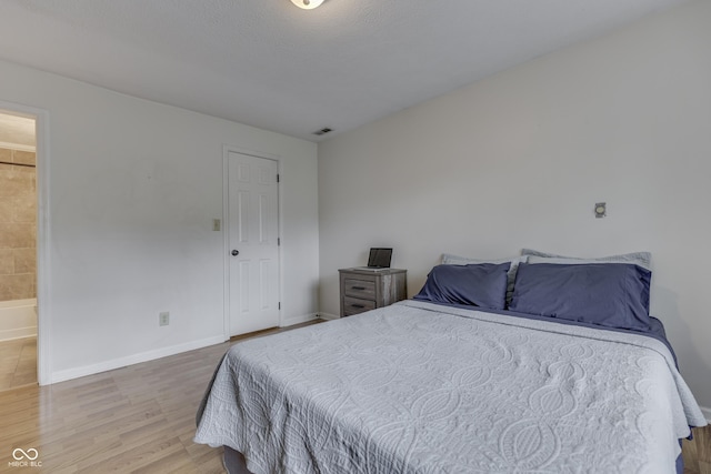 9676 Spruce Ln, Fishers, IN 46038 - bedroom featuring wood finished floors and ensuite bathroom