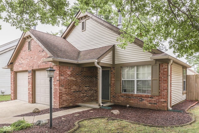 9676 Spruce Ln, Fishers, IN 46038 - view of front of house featuring an attached garage, brick siding, a shingled roof, and concrete driveway