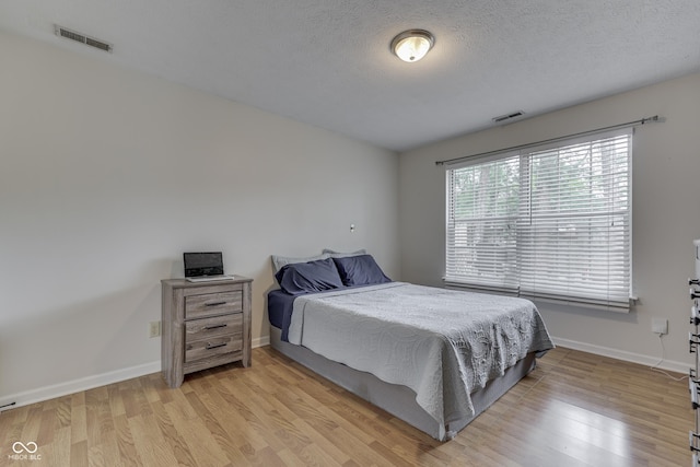 9676 Spruce Ln, Fishers, IN 46038 - bedroom with light wood-style flooring and a textured ceiling