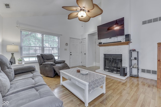 9676 Spruce Ln, Fishers, IN 46038 - living area with high vaulted ceiling, ceiling fan, wood finished floors, and a brick fireplace