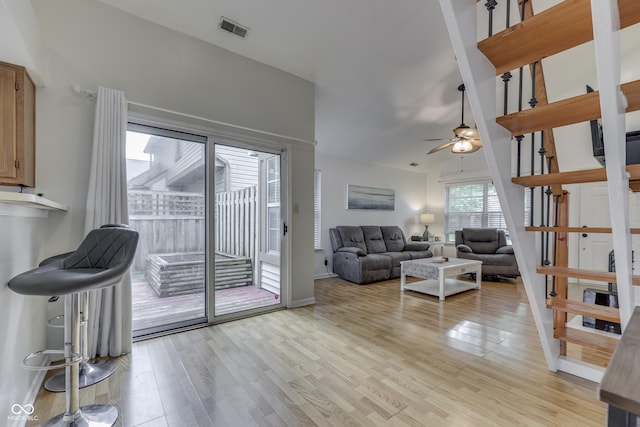 9676 Spruce Ln, Fishers, IN 46038 - living room with ceiling fan, light wood-style flooring, and stairway