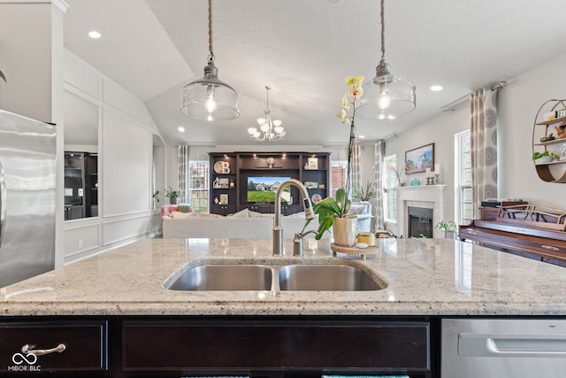 13816 Ambria Dr, Mccordsville, IN 46055 - kitchen with open floor plan, stainless steel appliances, a center island with sink, a fireplace, and recessed lighting