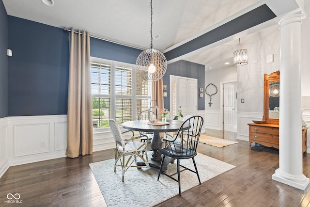 13816 Ambria Dr, Mccordsville, IN 46055 - dining area featuring ornate columns, a chandelier, dark wood-type flooring, a decorative wall, and a wainscoted wall