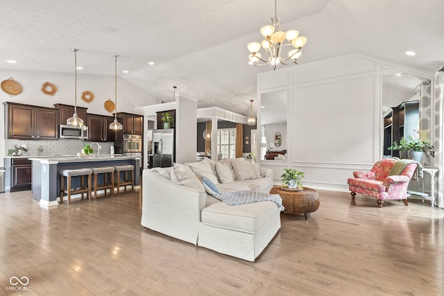 13816 Ambria Dr, Mccordsville, IN 46055 - living area featuring lofted ceiling, a chandelier, light wood-style floors, and recessed lighting