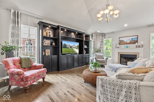 13816 Ambria Dr, Mccordsville, IN 46055 - living area with light wood-style floors, a chandelier, a tiled fireplace, recessed lighting, and vaulted ceiling