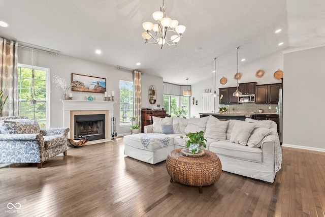 13816 Ambria Dr, Mccordsville, IN 46055 - living room with a chandelier, plenty of natural light, recessed lighting, dark wood-style floors, and a tiled fireplace