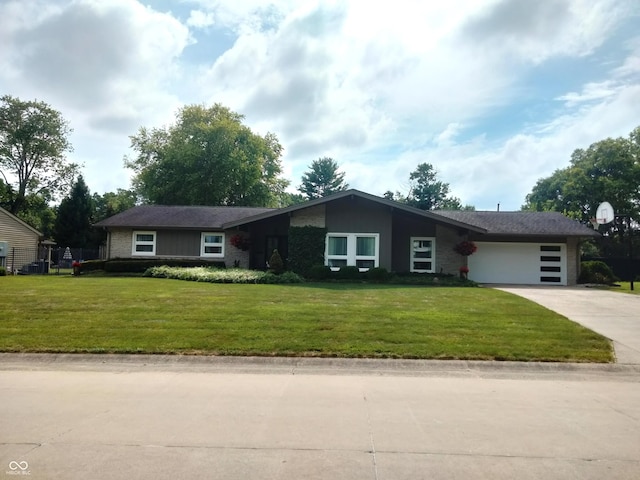 4008 Washington St, Columbus, IN 47203 - view of front of house with concrete driveway, a garage, and a front yard