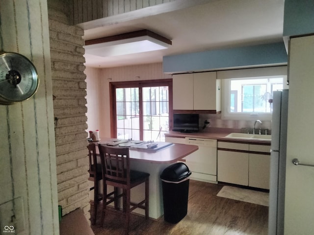 4008 Washington St, Columbus, IN 47203 - kitchen featuring white appliances, white cabinets, dark wood finished floors, and light countertops