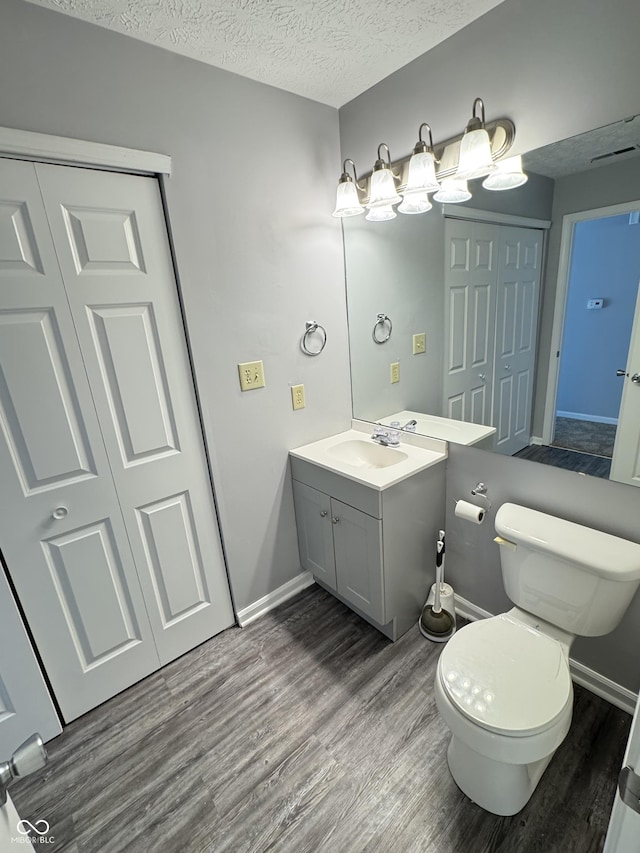 9716 Spruce Ln, Fishers, IN 46038 - half bathroom with wood finished floors, vanity, and a textured ceiling