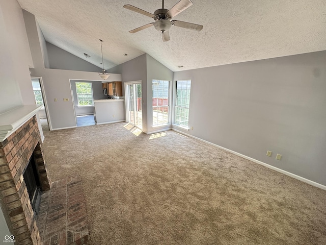 9716 Spruce Ln, Fishers, IN 46038 - unfurnished living room featuring a textured ceiling, a brick fireplace, lofted ceiling, carpet floors, and a ceiling fan