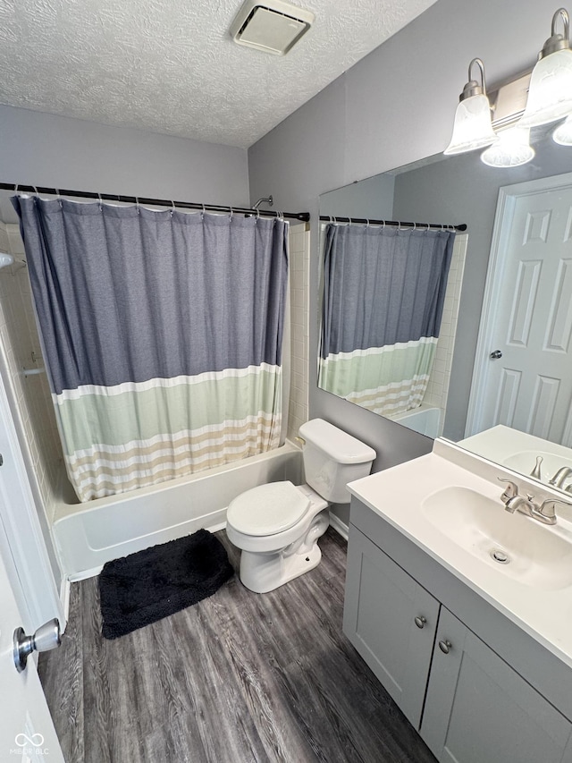 9716 Spruce Ln, Fishers, IN 46038 - bathroom with shower / tub combo, vanity, wood finished floors, and a textured ceiling