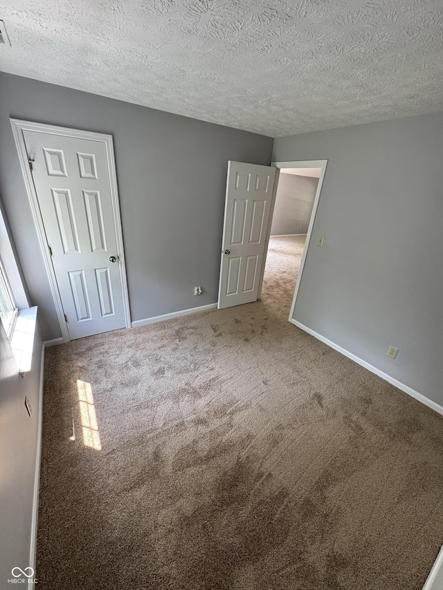 9716 Spruce Ln, Fishers, IN 46038 - spare room with carpet flooring and a textured ceiling