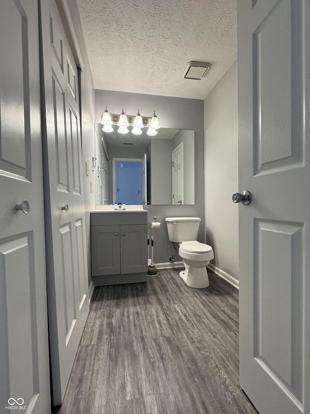 9716 Spruce Ln, Fishers, IN 46038 - bathroom featuring wood finished floors, vanity, and a textured ceiling