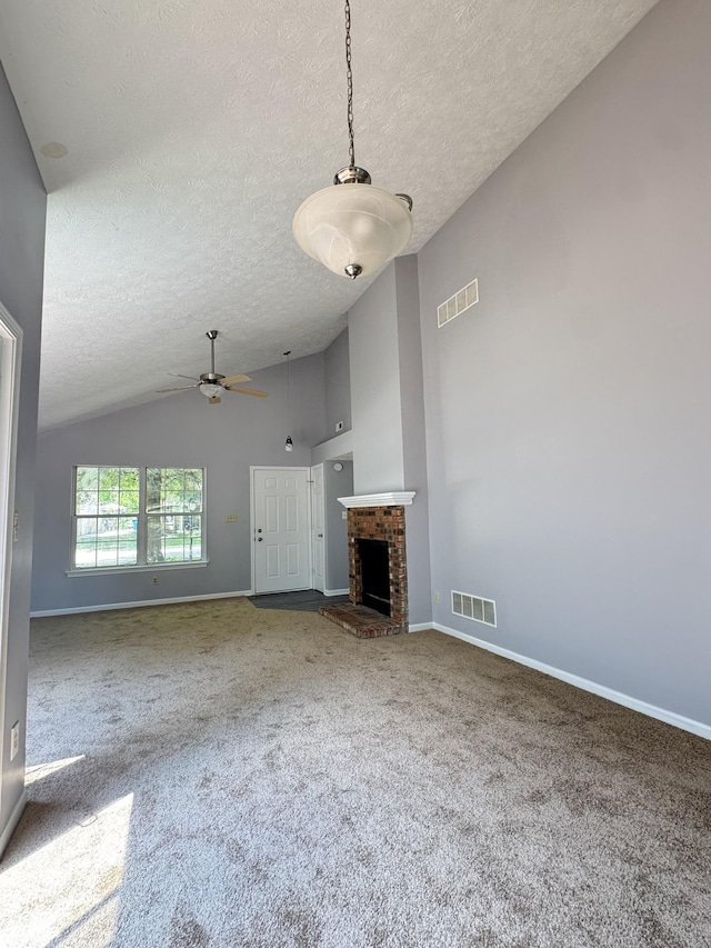 9716 Spruce Ln, Fishers, IN 46038 - unfurnished living room featuring vaulted ceiling, a textured ceiling, ceiling fan, carpet floors, and a fireplace