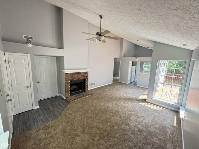 9716 Spruce Ln, Fishers, IN 46038 - unfurnished living room featuring a ceiling fan, carpet floors, a fireplace, a textured ceiling, and high vaulted ceiling