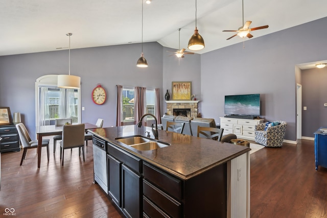 897 Sommersweet Run, Greenwood, IN 46143 - kitchen with a ceiling fan, dark countertops, dishwasher, a fireplace, and plenty of natural light