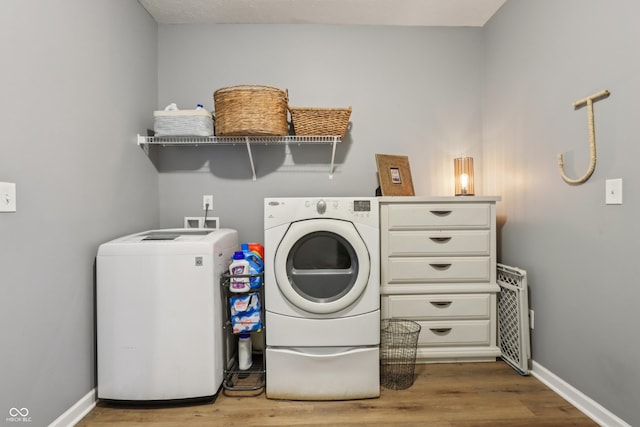 897 Sommersweet Run, Greenwood, IN 46143 - laundry room featuring washing machine and clothes dryer and wood finished floors