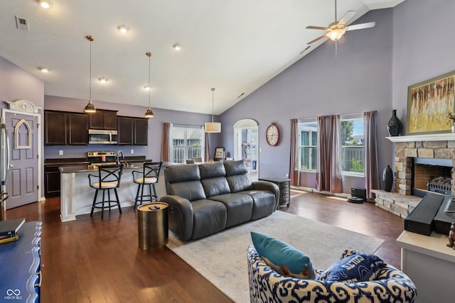 897 Sommersweet Run, Greenwood, IN 46143 - living area with ceiling fan, plenty of natural light, dark wood finished floors, high vaulted ceiling, and a fireplace